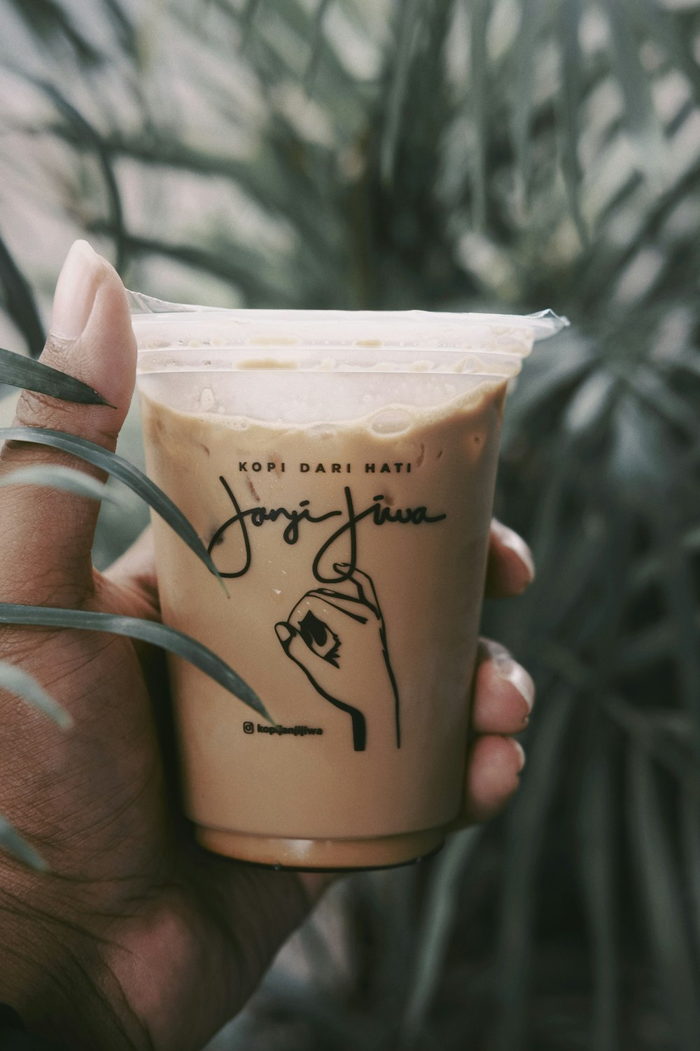 person holding brown coffee cup