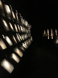 A horizontally scrolling overlay of high-resolution cinematic scenes with glowing transparent cards floating in a blurred glass filter.