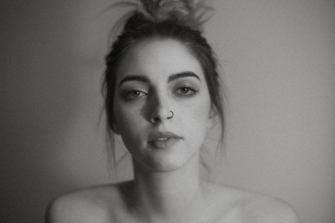 woman with black hair in grayscale photography,