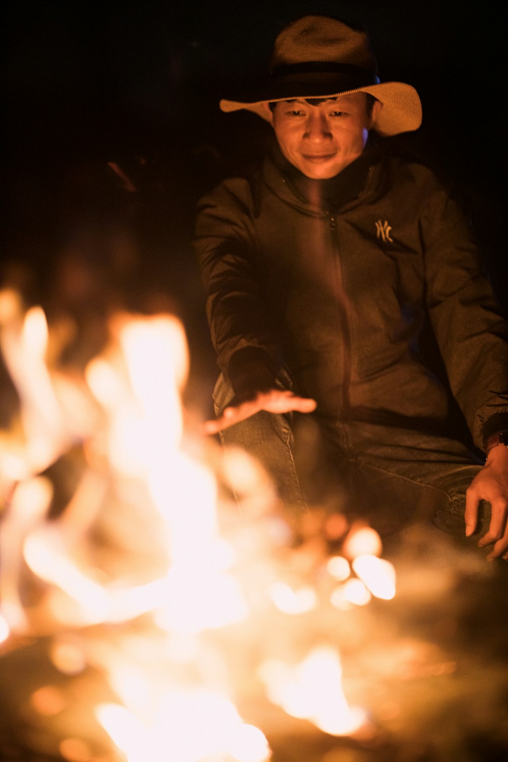 man in black jacket holding fire