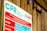 A sign detailing cardiopulmonary resuscitation (CPR) instructions, positioned against a wooden wall. The text includes warnings and response tips and highlights the importance of supervision around pools.