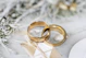 gold wedding band on white textile