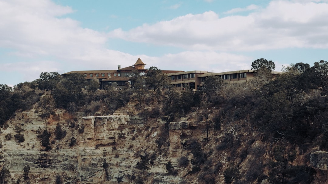 brown concrete building on brown rocky mountain under blue sky during daytime