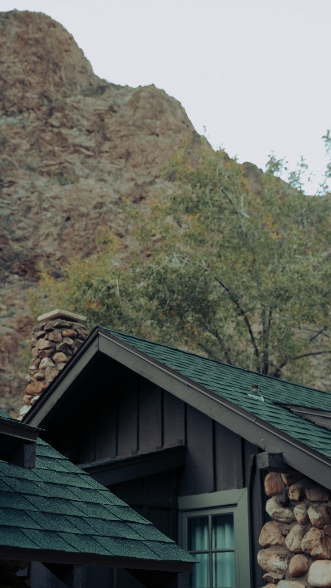 gray wooden house near green trees during daytime