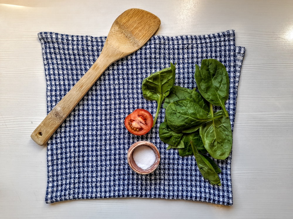 brown wooden spoon on blue and white checkered textile