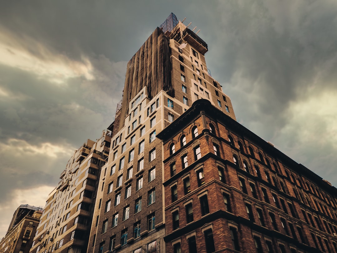 brown concrete building under cloudy sky during daytime