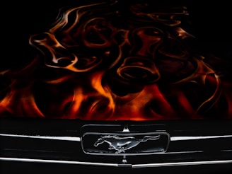 Display of various Mustang parts including brake calipers, headlights, and grilles.