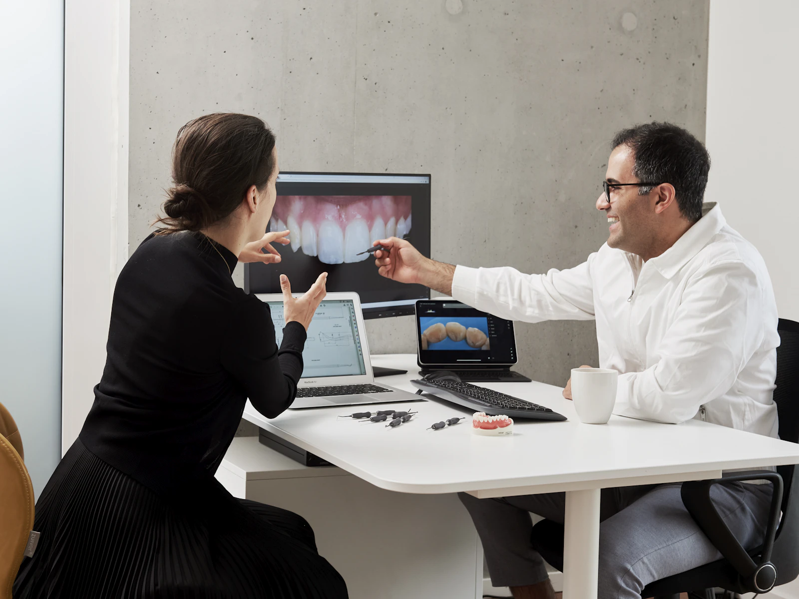 Sydney dentist reviewing a digital scan of a patient's teeth during a consultation about sensitive teeth treatment