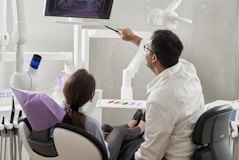 Dental Consultation with Patient explaining Radiograph of teeth 