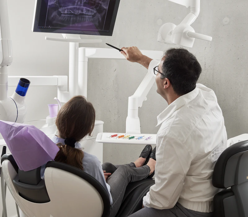 Dentist consulting with a patient in a modern treatment room
