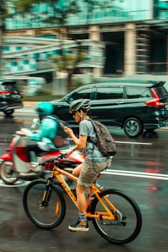 A city commuter using an urban mobility app on a bike