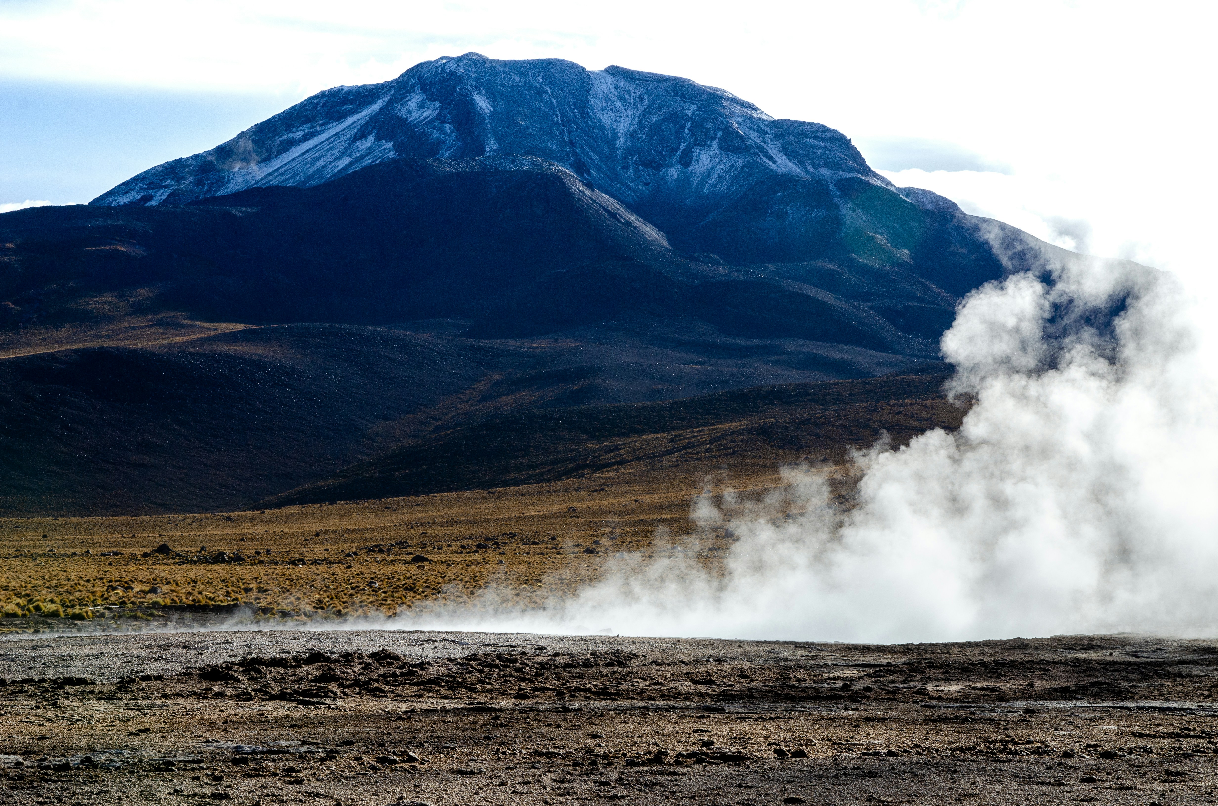 geothermal steam vents at el tatio geyser field at sunrise