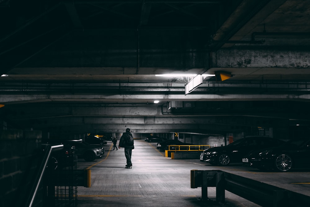 man in black jacket walking on train station