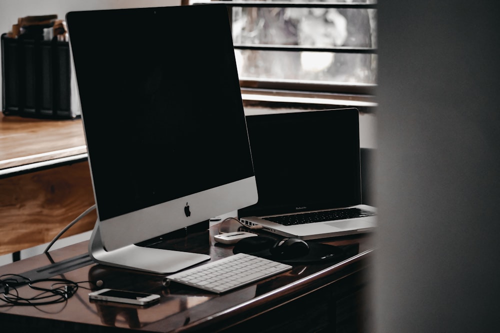 silver imac on black table