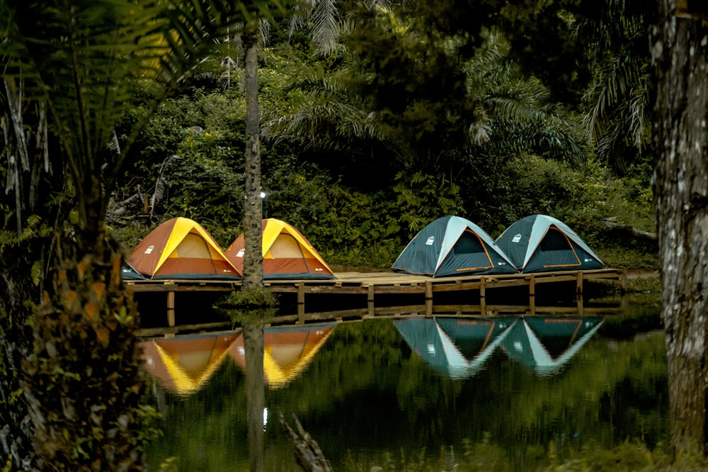 green and yellow wooden house on lake