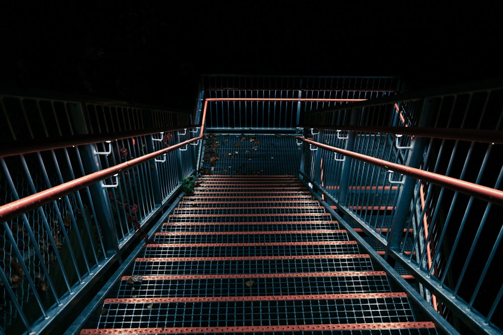 brown wooden staircase with stainless steel railings