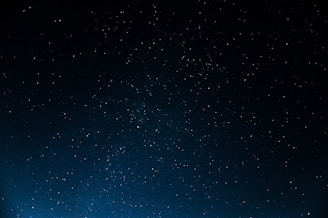 A vast, dark night sky dotted with numerous white, twinkling stars. The image conveys a sense of infinity and tranquility, with no visible horizon or earthly features.
