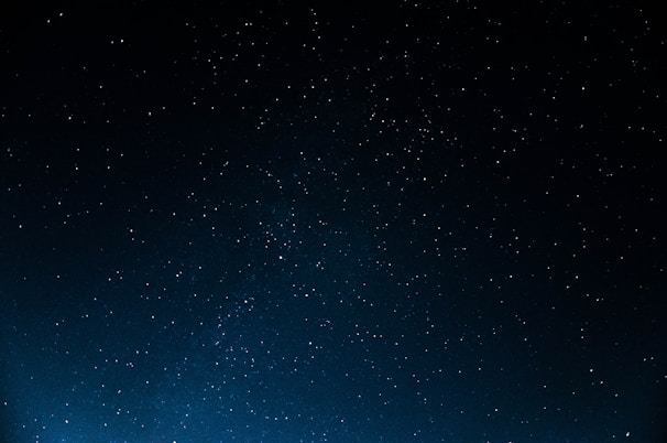 A vast, dark night sky dotted with numerous white, twinkling stars. The image conveys a sense of infinity and tranquility, with no visible horizon or earthly features.