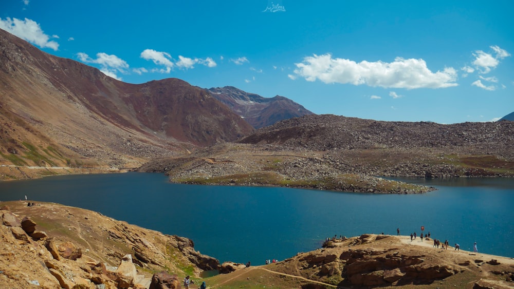 lake in the middle of mountains during daytime