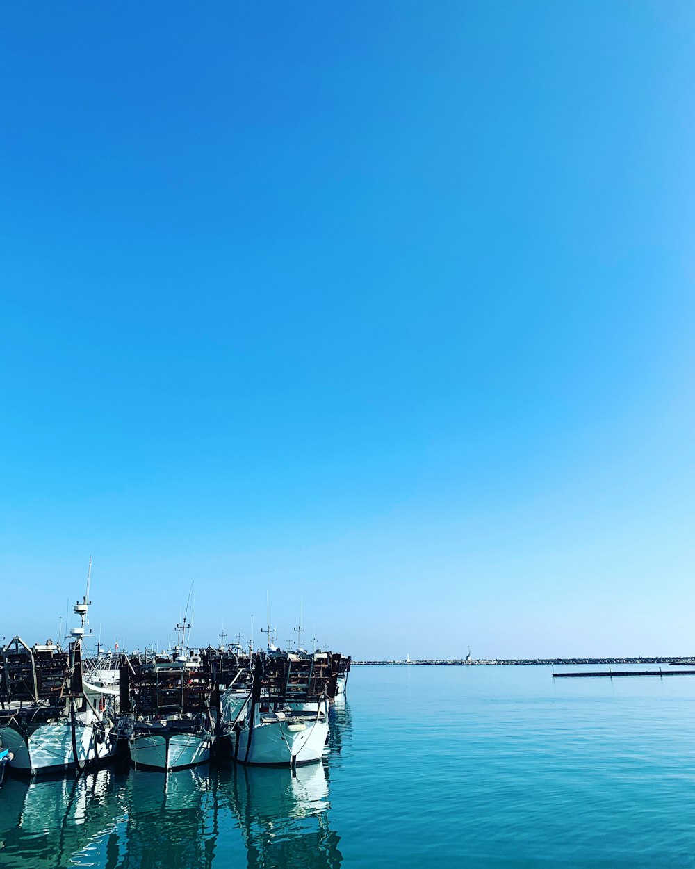 boat on sea under blue sky during daytime