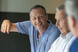 man in blue polo shirt smiling