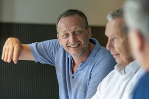 man in blue polo shirt smiling