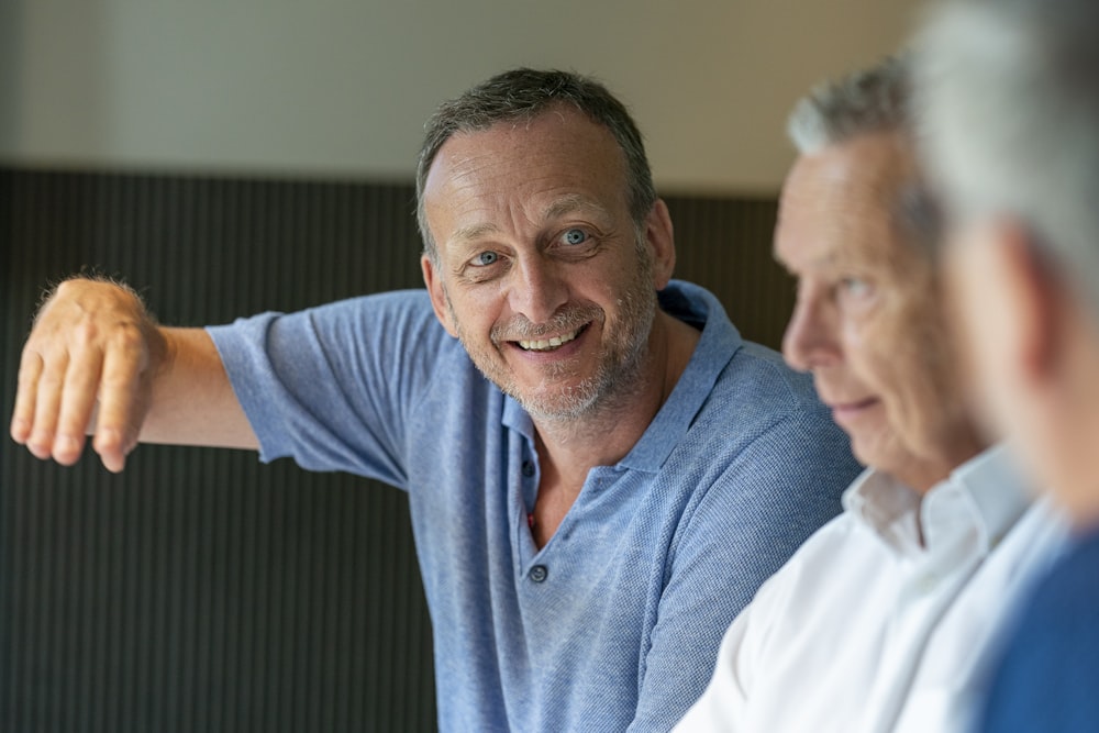 man in blue polo shirt smiling