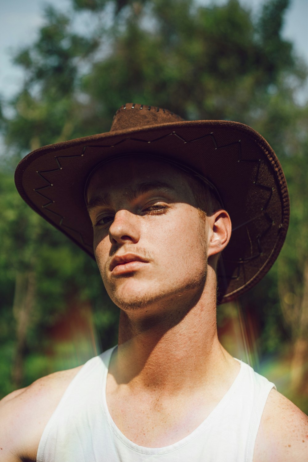 Hombre con camisa de cuello blanco con sombrero negro