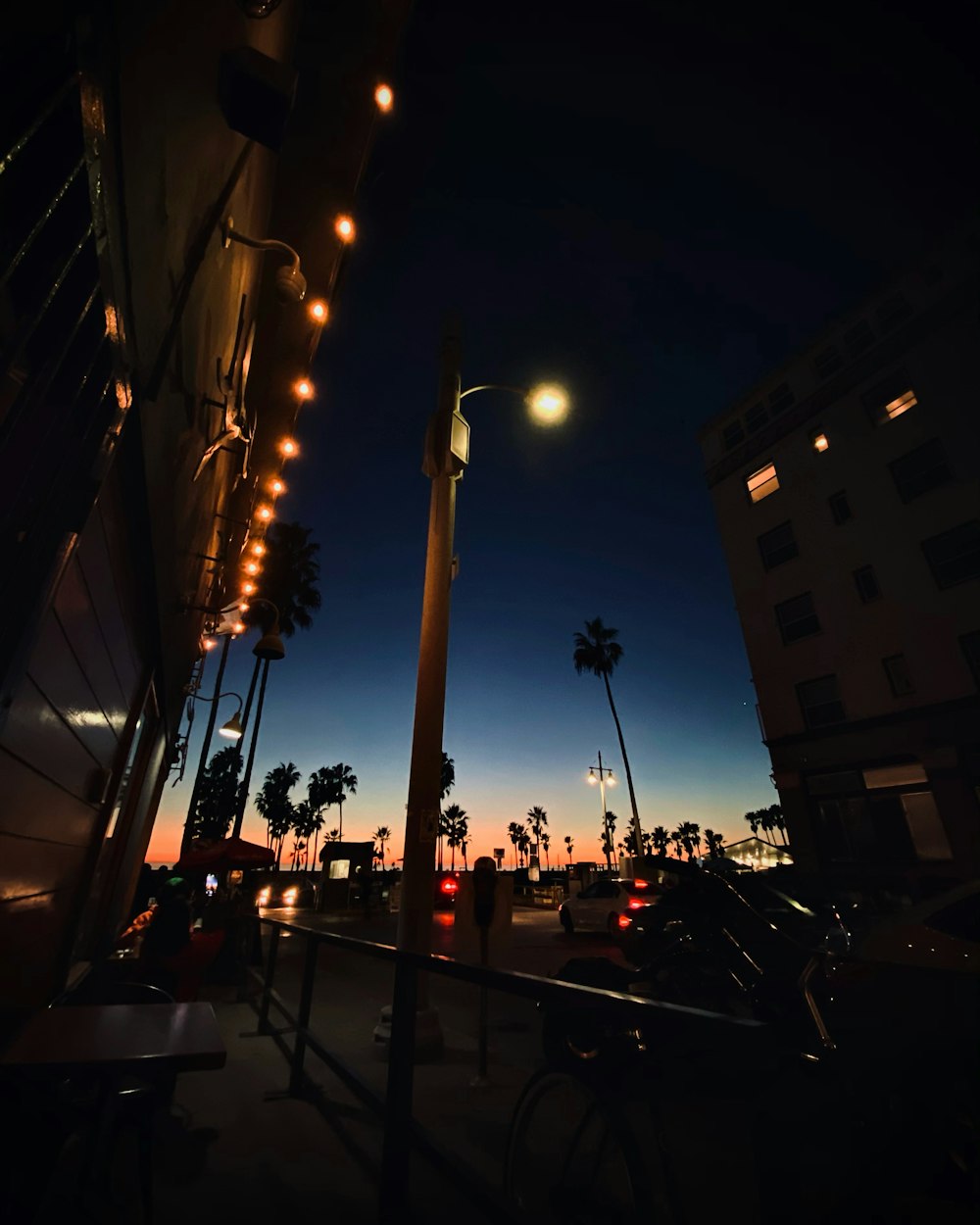 cars parked beside building during night time