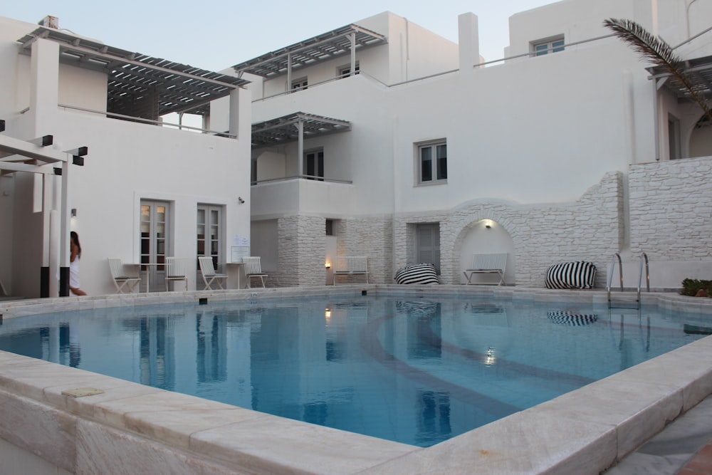 white concrete building near swimming pool during daytime