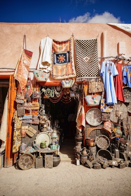 assorted clothes hanged on brown wooden cabinet