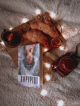 A cozy study corner with Lithuanian language books and a steaming cup of tea by the window.