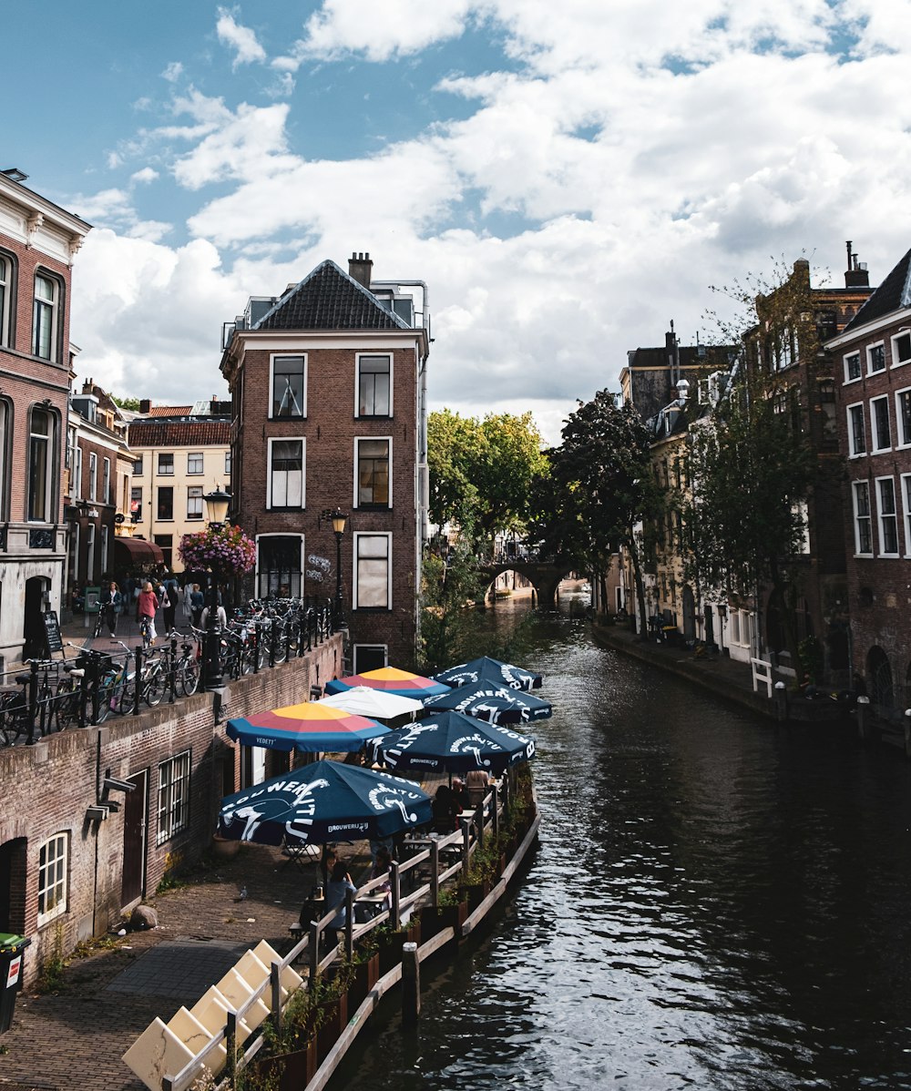 blue boat on river between buildings during daytime