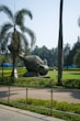 grey elephant statue on green grass field during daytime