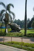 grey elephant statue on green grass field during daytime