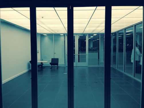 A sleek, dark-toned office space with minimalist geometric lines highlighting a modern workspace.