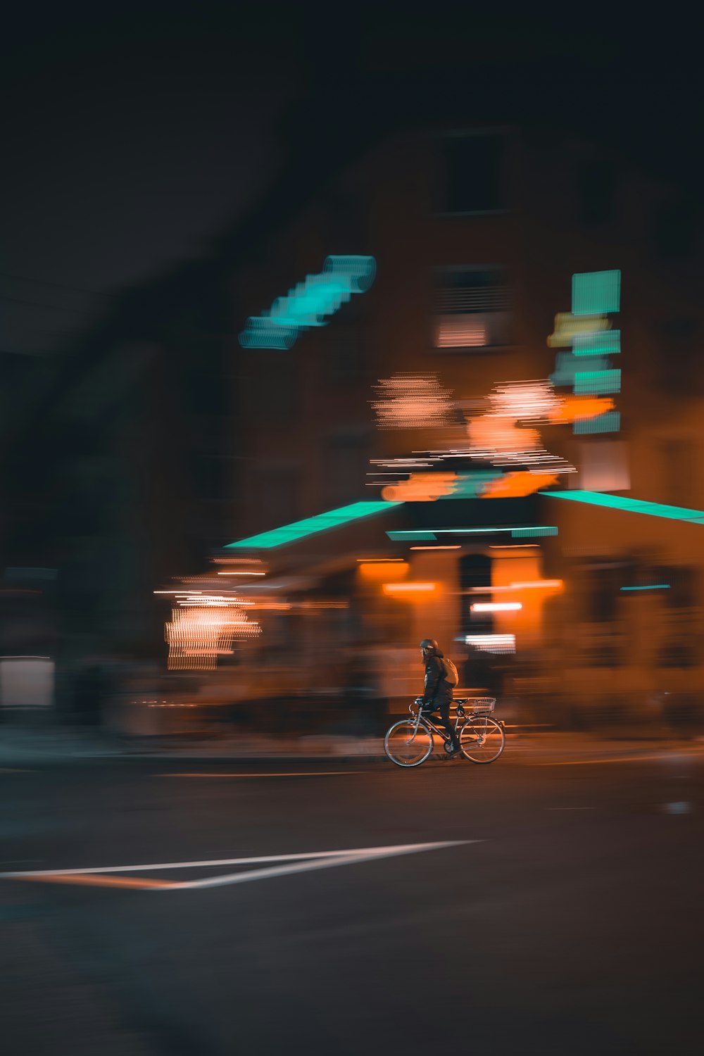 man riding bicycle on road during night time