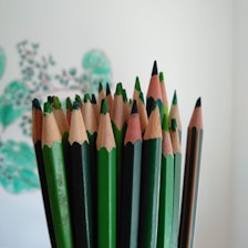 green color pencils on white surface