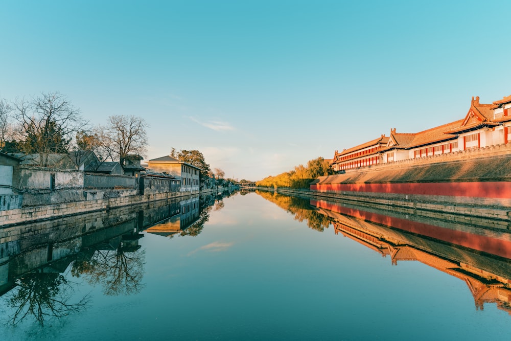 brown and white concrete building beside river during daytime