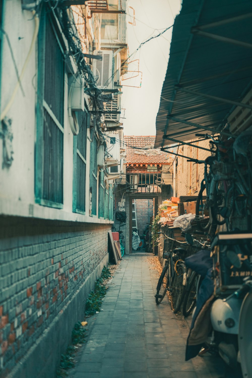 black bicycle parked beside gray concrete building during daytime