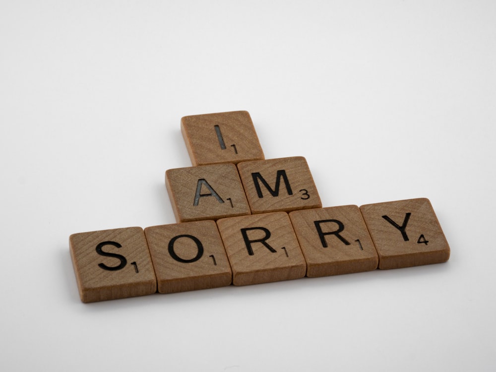 brown wooden letter blocks on white surface