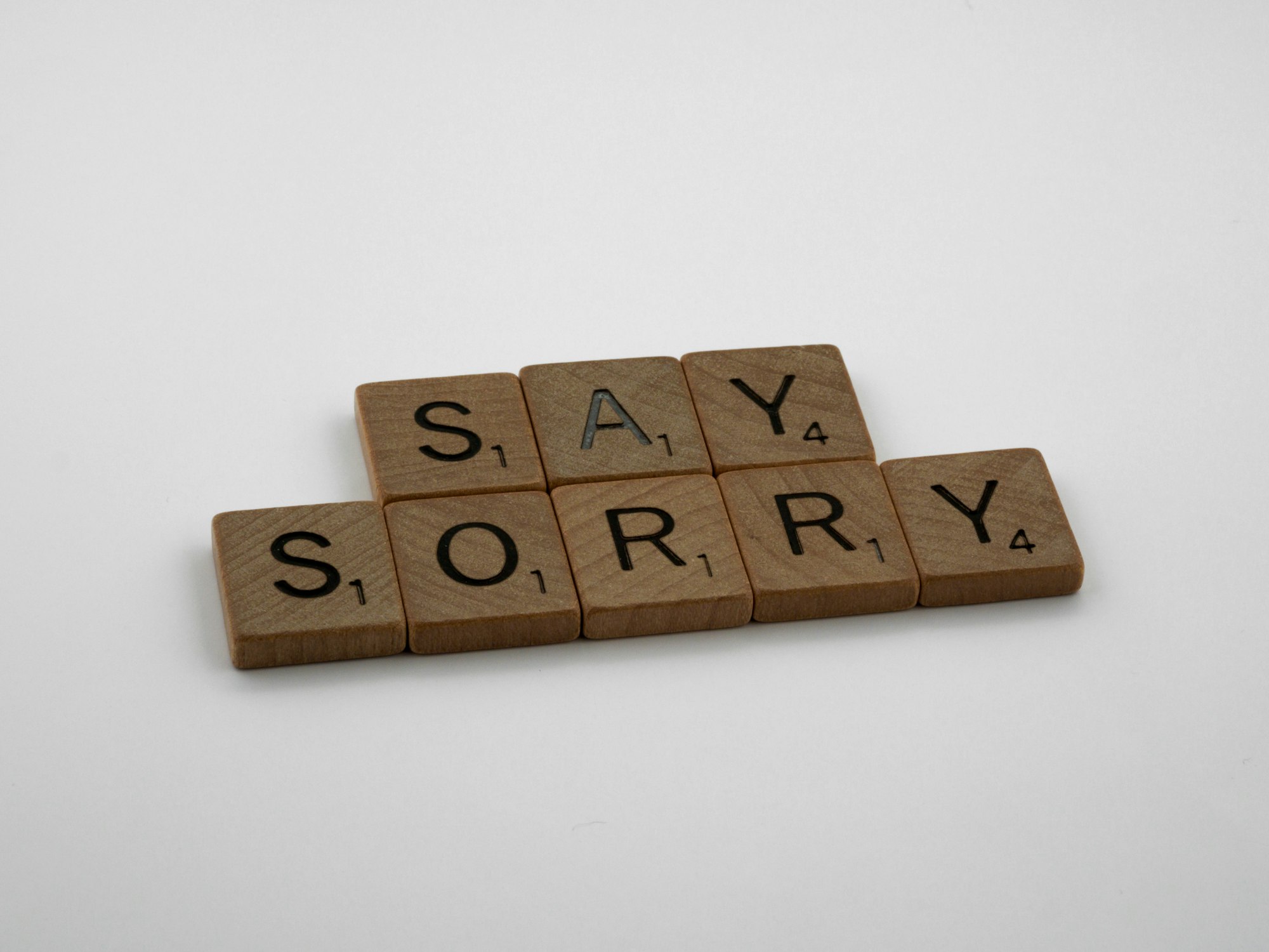 scrabble, scrabble pieces, lettering, letters, wood, scrabble tiles, white background, words, type, typography, design, layout, i am sorry, sorry, apologise, say sorry, regret, make up, break up, mistake, hardest word, 
