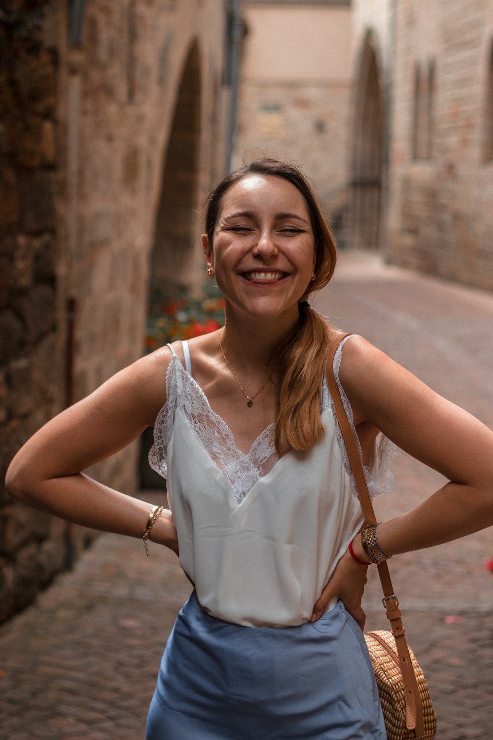smiling woman in white sleeveless top