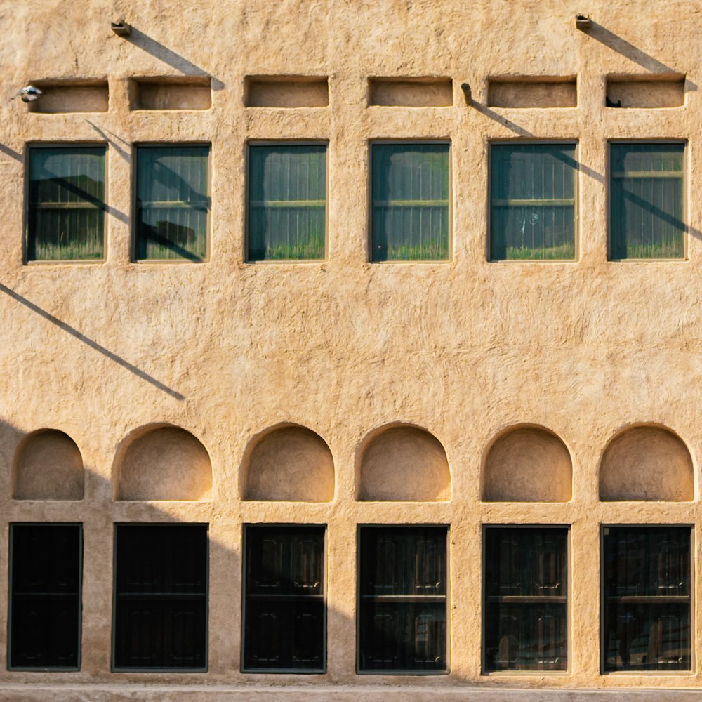 brown concrete building with blue windows