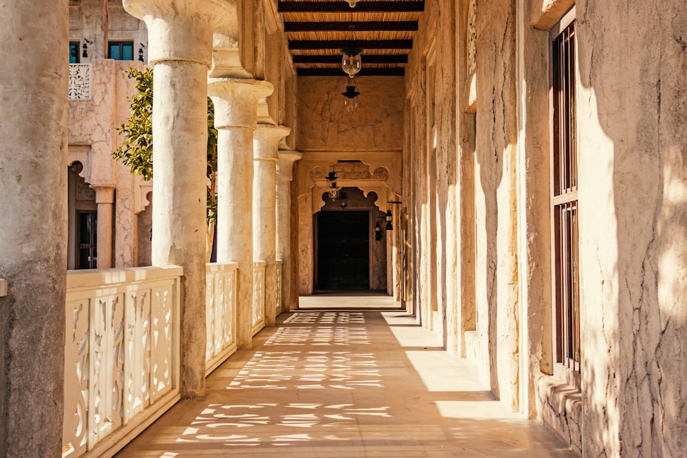 brown concrete hallway with arch shaped windows