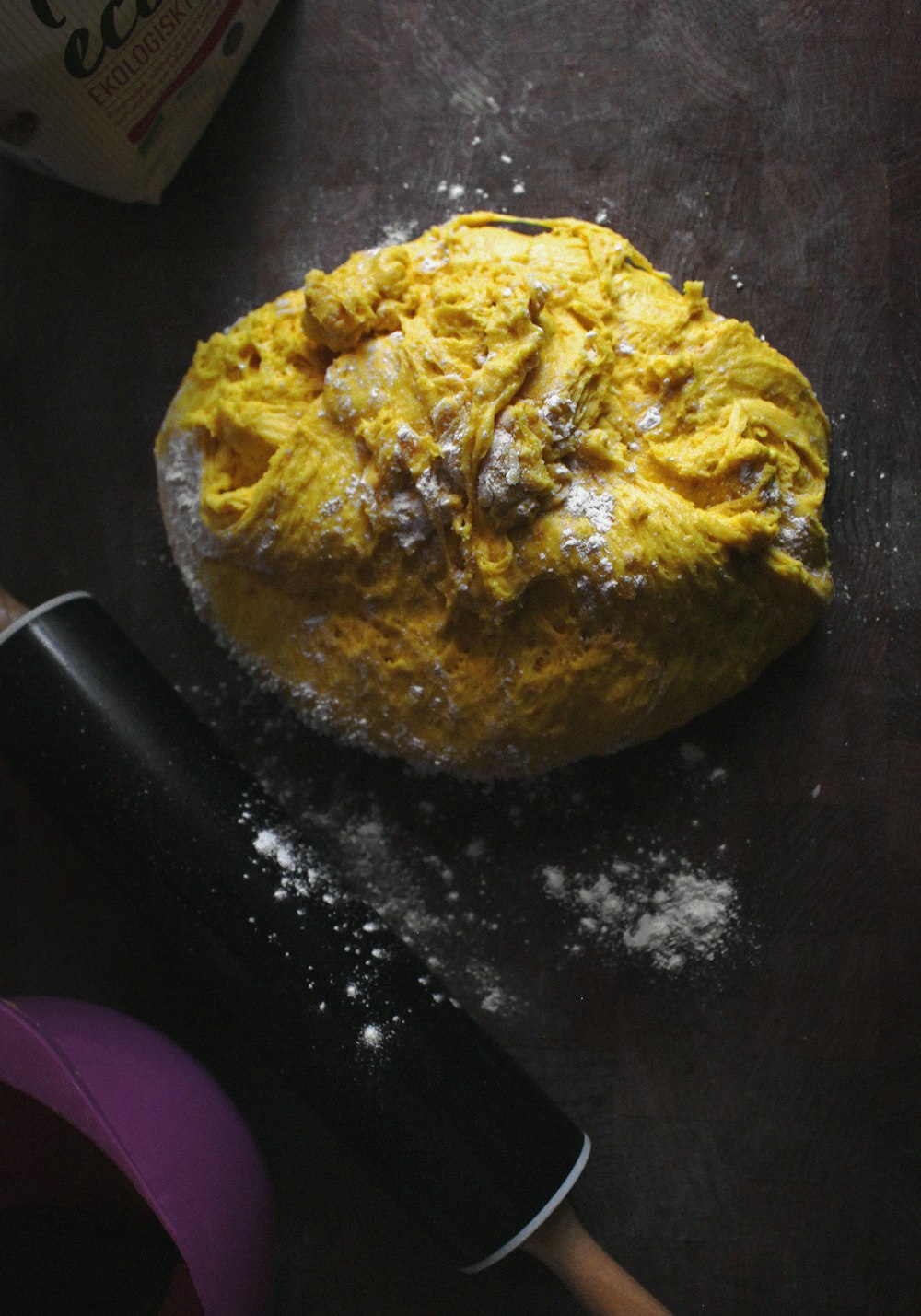 a ball of dough sitting on top of a table next to a knife