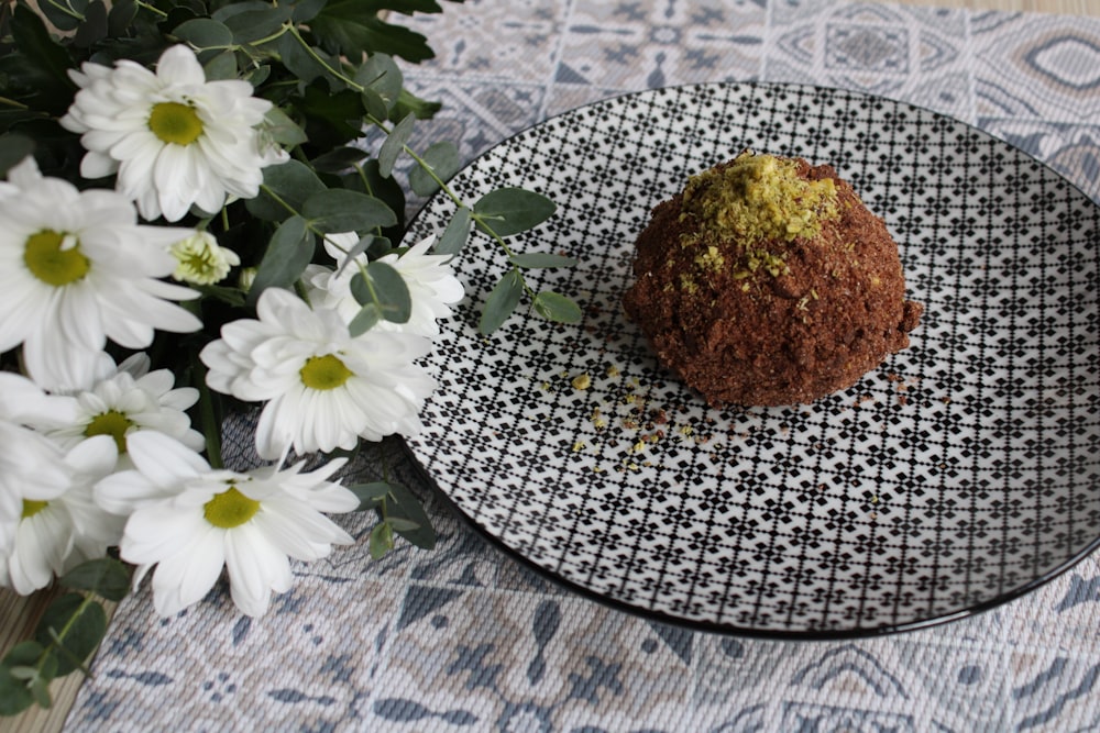 brown bread on white and black floral round plate