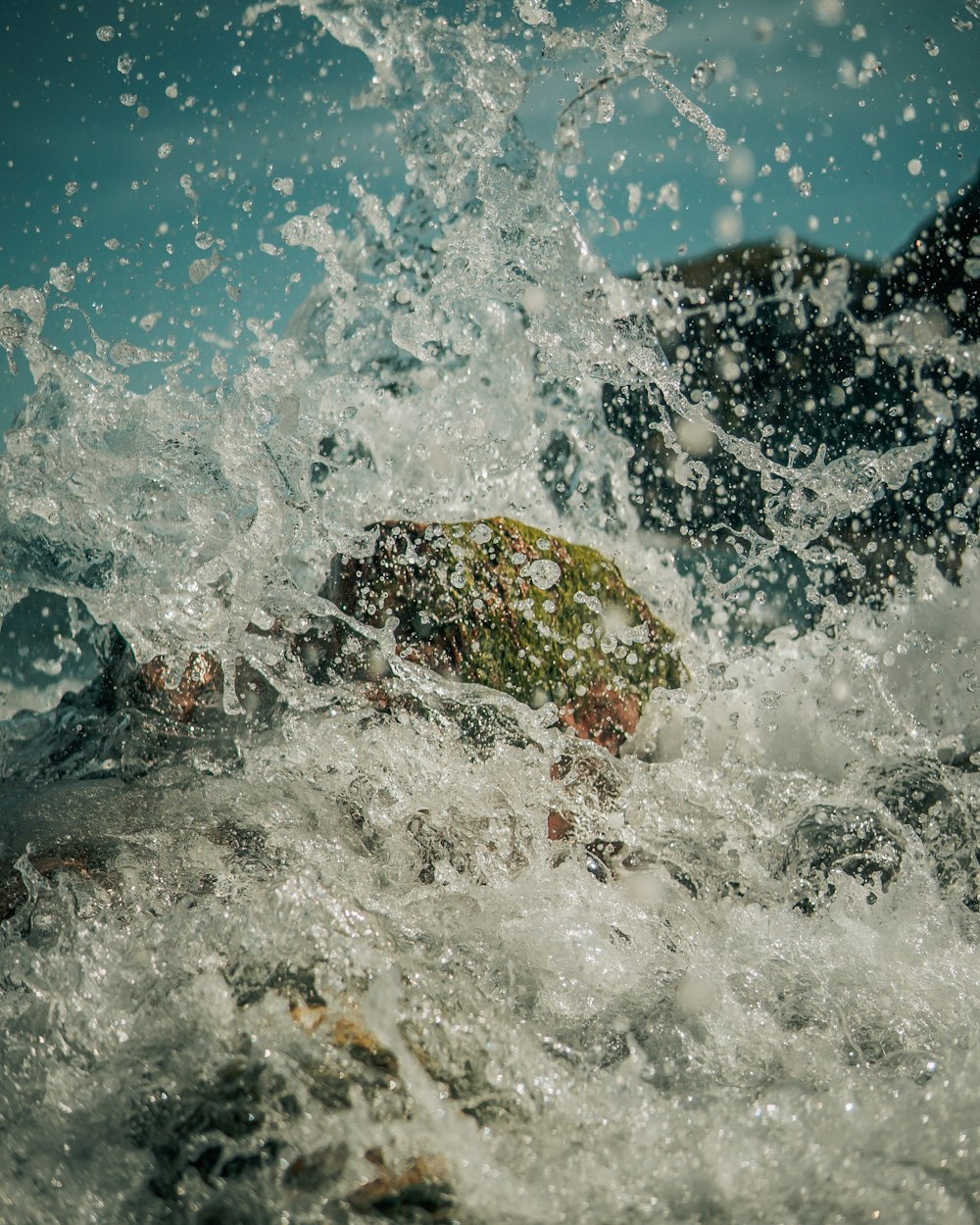 water waves hitting rocks during daytime