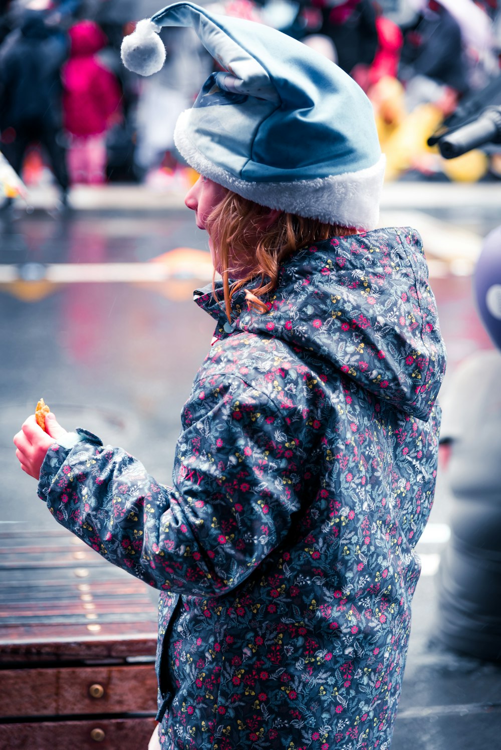 woman in blue bucket hat and brown and black long sleeve shirt holding cigarette stick