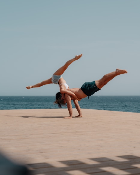 man in red shorts jumping on beach during daytime